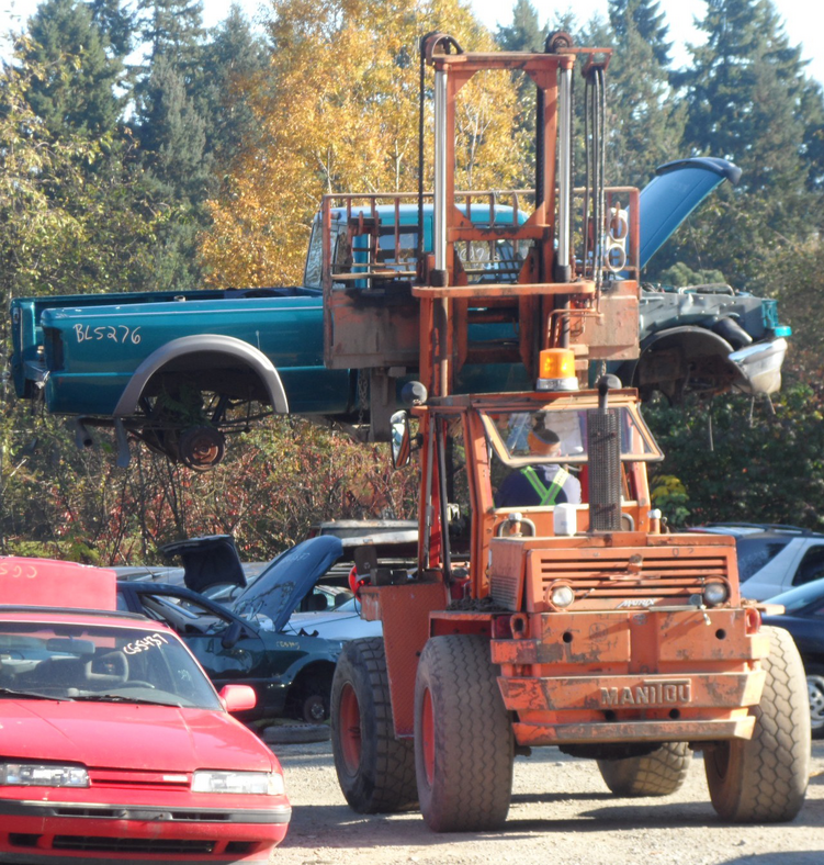 Dameged SUV lifted by Forklift